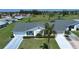 An aerial view of a well maintained single-story home, with a lush green lawn and a long driveway at 322 Club Manor Dr, Sun City Center, FL 33573