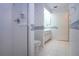 Bathroom with a glass shower, toilet, and vanity plus floral wallpaper at 322 Club Manor Dr, Sun City Center, FL 33573
