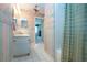 View of the bathroom with a vanity and white tile floors plus a shower and access to the main bedroom at 322 Club Manor Dr, Sun City Center, FL 33573