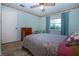 Bedroom with light walls, wood-look flooring, a window, and a ceiling fan at 322 Club Manor Dr, Sun City Center, FL 33573