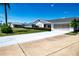 Charming single-story home featuring well-maintained landscaping and an attached garage at 322 Club Manor Dr, Sun City Center, FL 33573