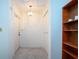 Clean hallway with neutral walls and decorative lighting, with built in shelves at 322 Club Manor Dr, Sun City Center, FL 33573