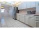 Kitchen featuring stainless steel refrigerator and ample cabinet space at 322 Club Manor Dr, Sun City Center, FL 33573
