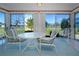Enclosed lanai with comfortable seating and view of the community lawn at 322 Club Manor Dr, Sun City Center, FL 33573