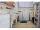 Laundry room features a sink, shelving, cabinets, a washer and dryer plus a water heater at 322 Club Manor Dr, Sun City Center, FL 33573