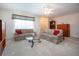 Comfortable living room with plush seating, soft carpet, and natural light at 322 Club Manor Dr, Sun City Center, FL 33573
