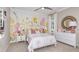 Charming bedroom with floral-themed wallpaper and decor, bright natural light, and an ornate mirror at 34088 Anchor Light Ln, Wesley Chapel, FL 33543