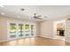 Large living area with wood floors and sliding doors to the pool area at 3425 Lacewood Rd, Tampa, FL 33618