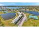 Picturesque aerial view showcasing the community's layout with multiple ponds, tennis courts, and residential buildings at 4766 Snook Se Dr, St Petersburg, FL 33705