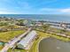 Stunning aerial view of a coastal community featuring residences, a lake, and partial ocean view at 4766 Snook Se Dr, St Petersburg, FL 33705