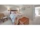 Cozy bedroom features a wicker bed frame and side chair for a relaxed, beach-themed retreat at 4766 Snook Se Dr, St Petersburg, FL 33705