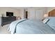 Cozy bedroom with a large bed, dresser, TV, closet, and a calm, comfortable atmosphere at 4766 Snook Se Dr, St Petersburg, FL 33705
