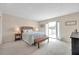Bright bedroom with a queen bed, access to the outside, beach decor, and neutral tones for a relaxing space at 4766 Snook Se Dr, St Petersburg, FL 33705
