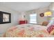 Comfortable bedroom with decorative mirror, wicker chair, and a serene beachy aesthetic at 4766 Snook Se Dr, St Petersburg, FL 33705
