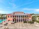 Exterior shot of building, showcasing balconies, pool, and palm trees in a tropical community at 4766 Snook Se Dr, St Petersburg, FL 33705
