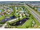Stunning aerial view showcasing the community's pool, ponds, green spaces, and nearby highway access at 5324 Moon Shell Dr, Apollo Beach, FL 33572