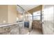 Bathroom showcasing a tiled shower with a glass door and a view of a blue-gray vanity and lighting at 5324 Moon Shell Dr, Apollo Beach, FL 33572