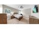 Bedroom features neutral walls, ceiling fan, comfortable bed, and window blinds for a relaxing space at 5324 Moon Shell Dr, Apollo Beach, FL 33572