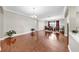 Formal dining room boasts hardwood floors, modern chandelier, and a dining table set for elegant entertaining at 5324 Moon Shell Dr, Apollo Beach, FL 33572