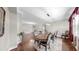 Formal dining room with hardwood floors, decorative rug, and chandelier lighting at 5324 Moon Shell Dr, Apollo Beach, FL 33572