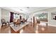 Formal dining room with elegant furnishings, hardwood floors, and living room view at 5324 Moon Shell Dr, Apollo Beach, FL 33572