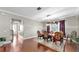 Elegant dining room with hardwood floors, decorative rug, and crystal chandelier at 5324 Moon Shell Dr, Apollo Beach, FL 33572