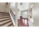 Inviting foyer with elegant double doors, wood flooring, and a staircase with decorative iron railings at 5324 Moon Shell Dr, Apollo Beach, FL 33572