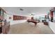 Large game room with pool table, comfortable seating area, and neutral carpet at 5324 Moon Shell Dr, Apollo Beach, FL 33572