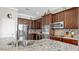 Granite countertop and backsplash adds to the charm of this kitchen with stainless appliances at 5324 Moon Shell Dr, Apollo Beach, FL 33572