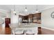 Kitchen island has bar stool seating and the kitchen also has stainless appliances and dark cabinetry at 5324 Moon Shell Dr, Apollo Beach, FL 33572