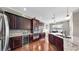 Kitchen has stainless appliances, granite counters, tile backsplash and dark wood cabinetry at 5324 Moon Shell Dr, Apollo Beach, FL 33572