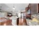 Open kitchen features granite counters, pendant lighting, stainless appliances and dark cabinets at 5324 Moon Shell Dr, Apollo Beach, FL 33572