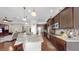 Open kitchen boasts granite counters, pendant lighting, stainless appliances and dark cabinets at 5324 Moon Shell Dr, Apollo Beach, FL 33572