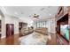 Open living room floor plan with hardwood floors, a ceiling fan and access to the kitchen at 5324 Moon Shell Dr, Apollo Beach, FL 33572