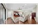 Cozy living room featuring hardwood floors, entertainment center, and comfortable seating at 5324 Moon Shell Dr, Apollo Beach, FL 33572