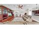 Spacious living area with a decorative entertainment center, leather recliners, and access to the kitchen at 5324 Moon Shell Dr, Apollo Beach, FL 33572