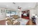 Open living room boasts hardwood floors and access to the kitchen and the outdoor patio at 5324 Moon Shell Dr, Apollo Beach, FL 33572
