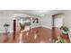 Open-concept living room featuring hardwood floors, neutral paint, and a comfortable seating area with modern lighting at 5324 Moon Shell Dr, Apollo Beach, FL 33572