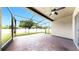Screened in patio featuring a tile floor, ceiling fan, and views of the backyard at 5324 Moon Shell Dr, Apollo Beach, FL 33572