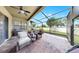 Screened patio with outdoor seating, ceiling fan, and backyard views at 5324 Moon Shell Dr, Apollo Beach, FL 33572