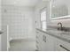 Bright, modern bathroom with glass block details, marble countertop, and contemporary fixtures at 540 59Th Ave, St Pete Beach, FL 33706