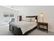 Cozy bedroom with dark furniture, neutral bedding, and a view of the patio at 540 59Th Ave, St Pete Beach, FL 33706