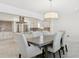 Elegant dining room with modern lighting and open view to the updated kitchen at 540 59Th Ave, St Pete Beach, FL 33706