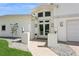 Welcoming front entrance with double doors, decorative wreaths, modern lighting, and a neatly landscaped walkway at 540 59Th Ave, St Pete Beach, FL 33706