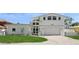 Beautiful two-story home boasts a manicured lawn and a welcoming front entrance with modern design elements at 540 59Th Ave, St Pete Beach, FL 33706