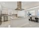 Modern kitchen featuring marble countertops, stainless steel appliances, and an open layout flowing to dining area at 540 59Th Ave, St Pete Beach, FL 33706