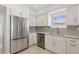 Bright kitchen features stainless steel appliances, marble countertops, and white cabinetry at 540 59Th Ave, St Pete Beach, FL 33706