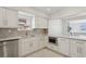 Modern kitchen boasts marble countertops, stainless steel appliances, and ample white cabinets at 540 59Th Ave, St Pete Beach, FL 33706