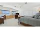 Bright main bedroom with a ceiling fan, large windows with water views, and a built-in desk area at 540 59Th Ave, St Pete Beach, FL 33706