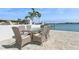 Outdoor dining area with seating for six and beautiful water views at 540 59Th Ave, St Pete Beach, FL 33706